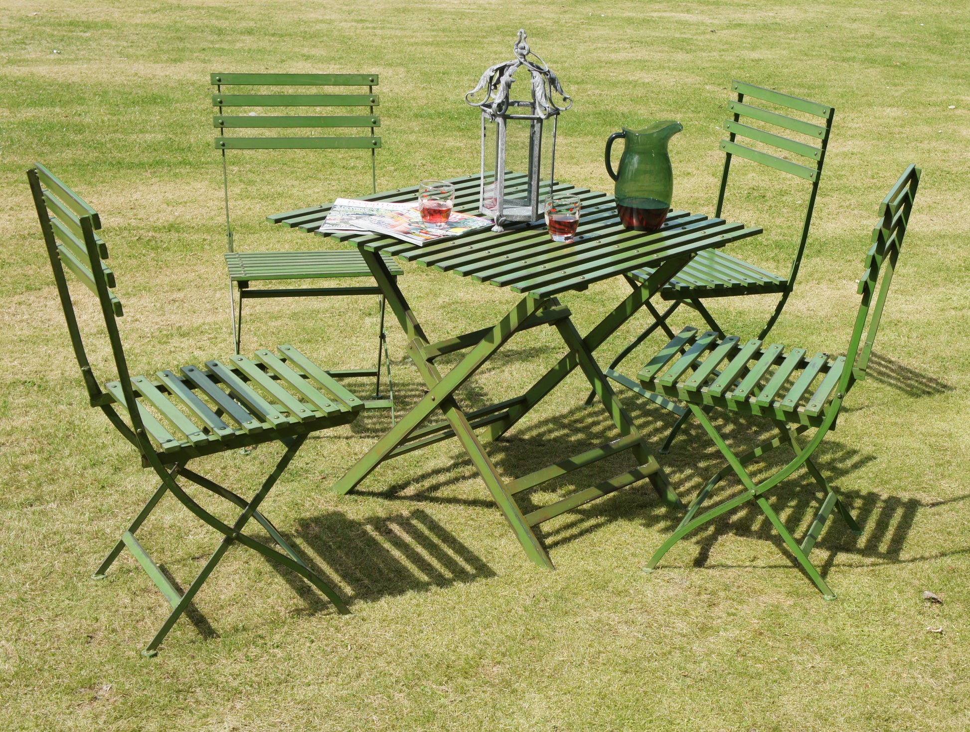 full set of green chairs and table on the grass