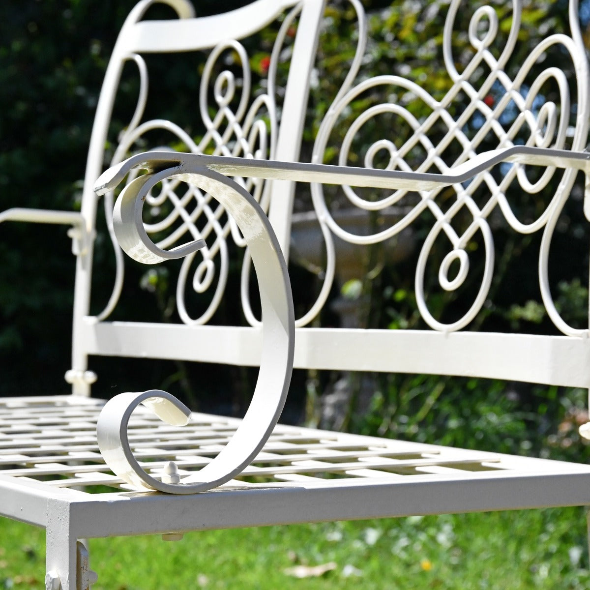 Close up of scroll work and filigree detailing on garden bench