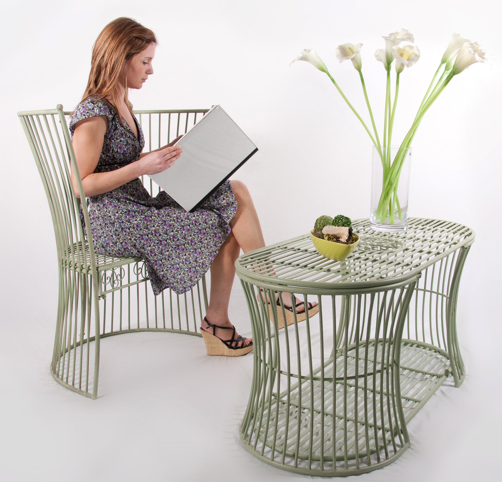 girl reading with green table and bench