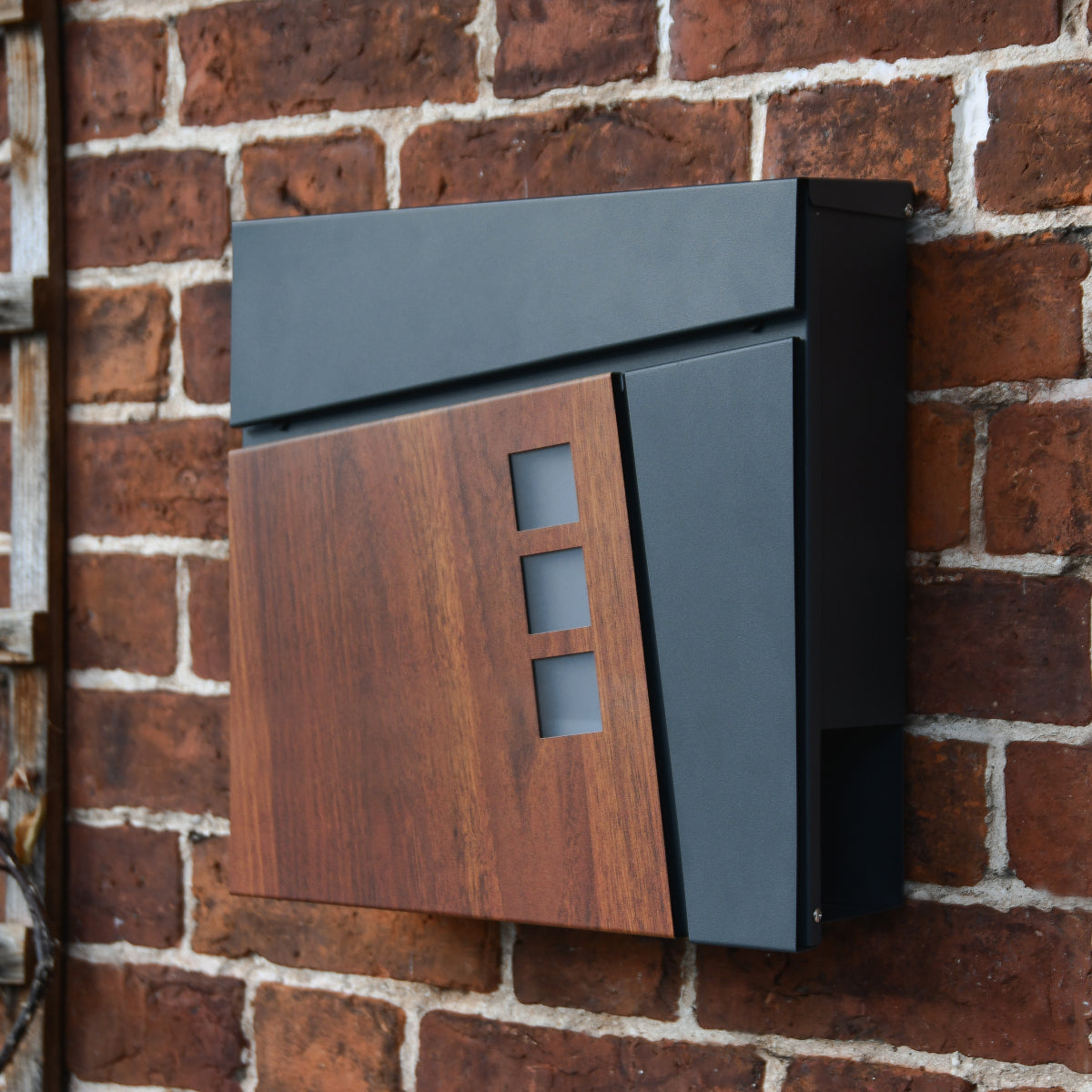 The 'Haines' newspaper holder and post box in situ
