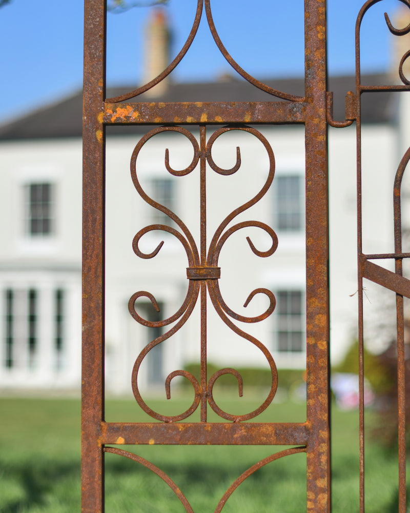 View of the scrolled motif on the perimeter of the rustic rose arch 