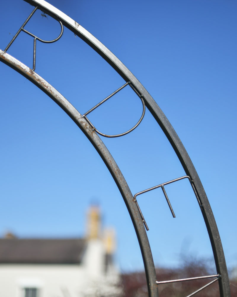 Close up of the lettering on the classical rose arch
