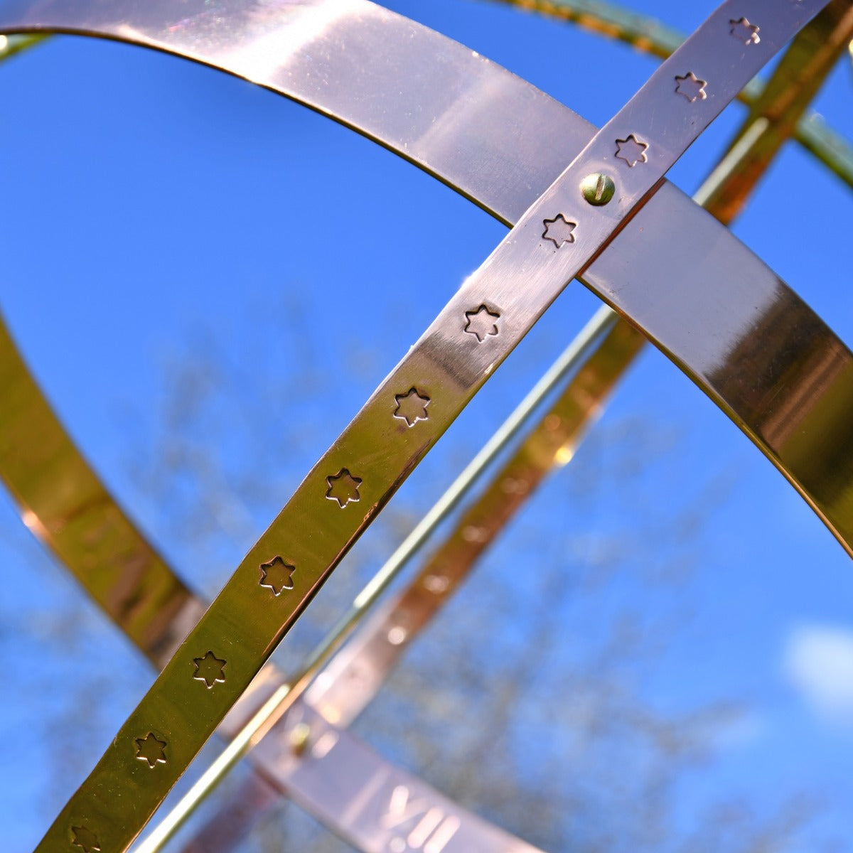 Close up of decorative finish on copper armillary sphere 