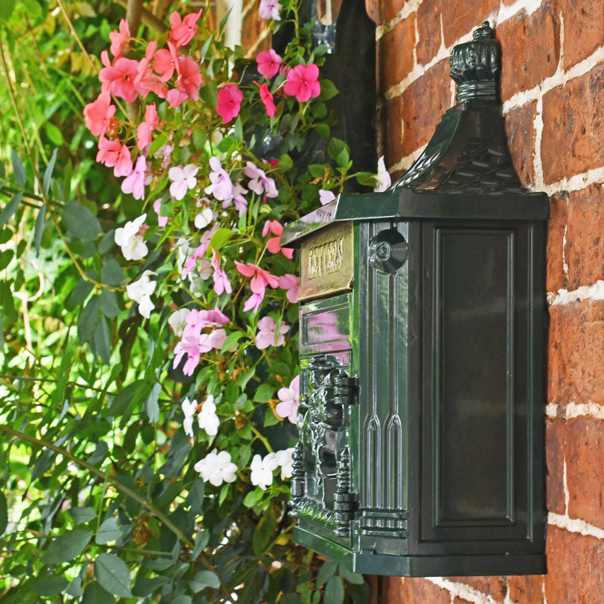 Side View of the "Huntley" Dark Green Wall Mounted Post Box Mounted on a Wall
