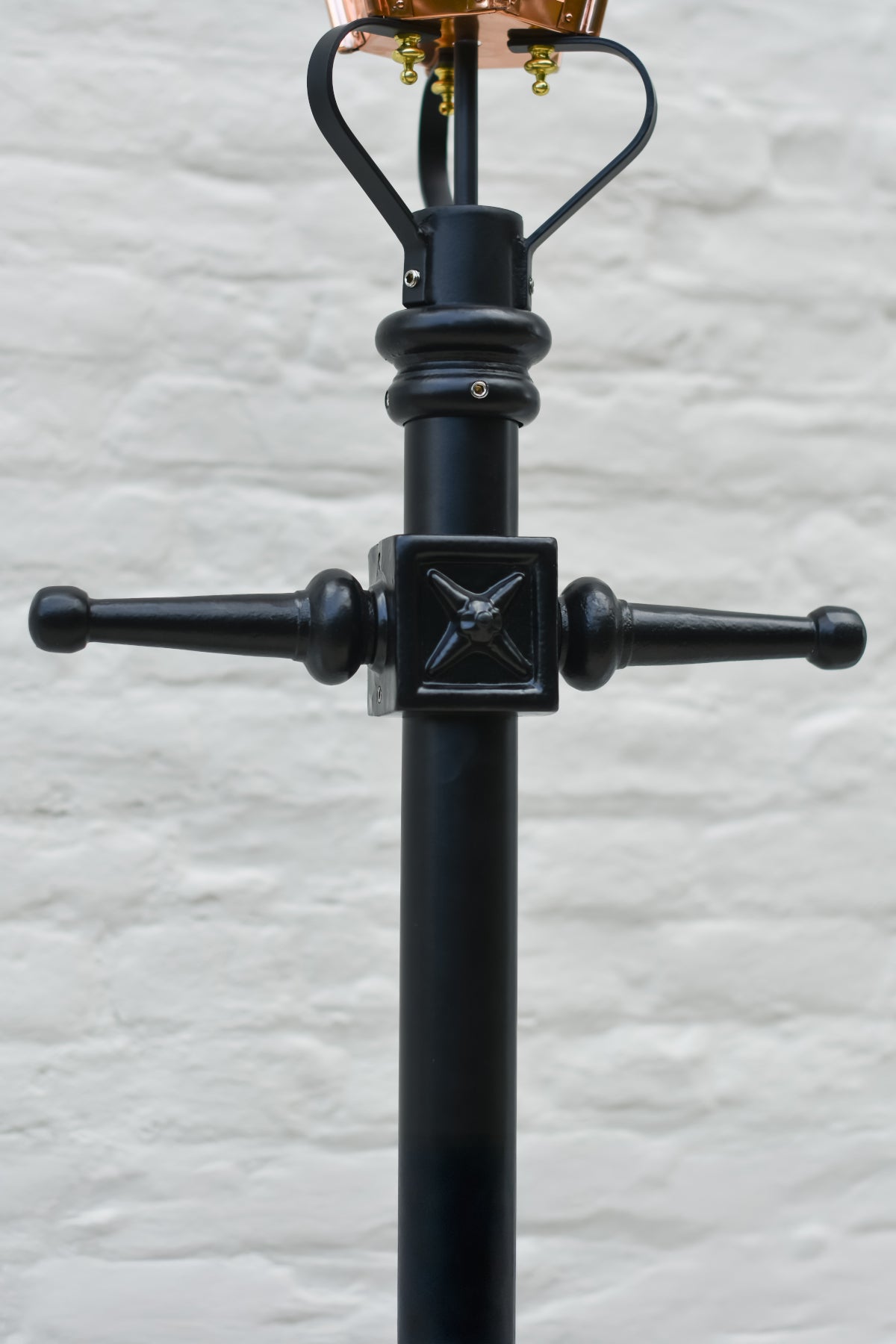 The black cast iron ladder bars on the garden lamp post