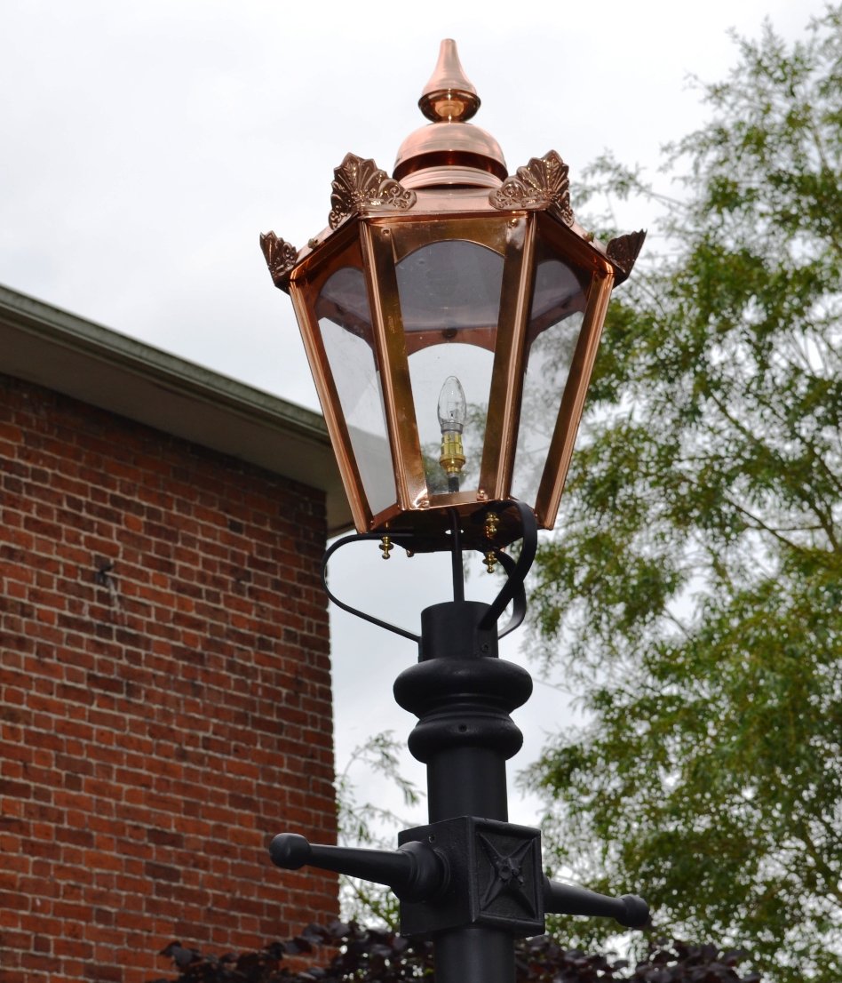 Large copper hexagonal lamp post in front of house