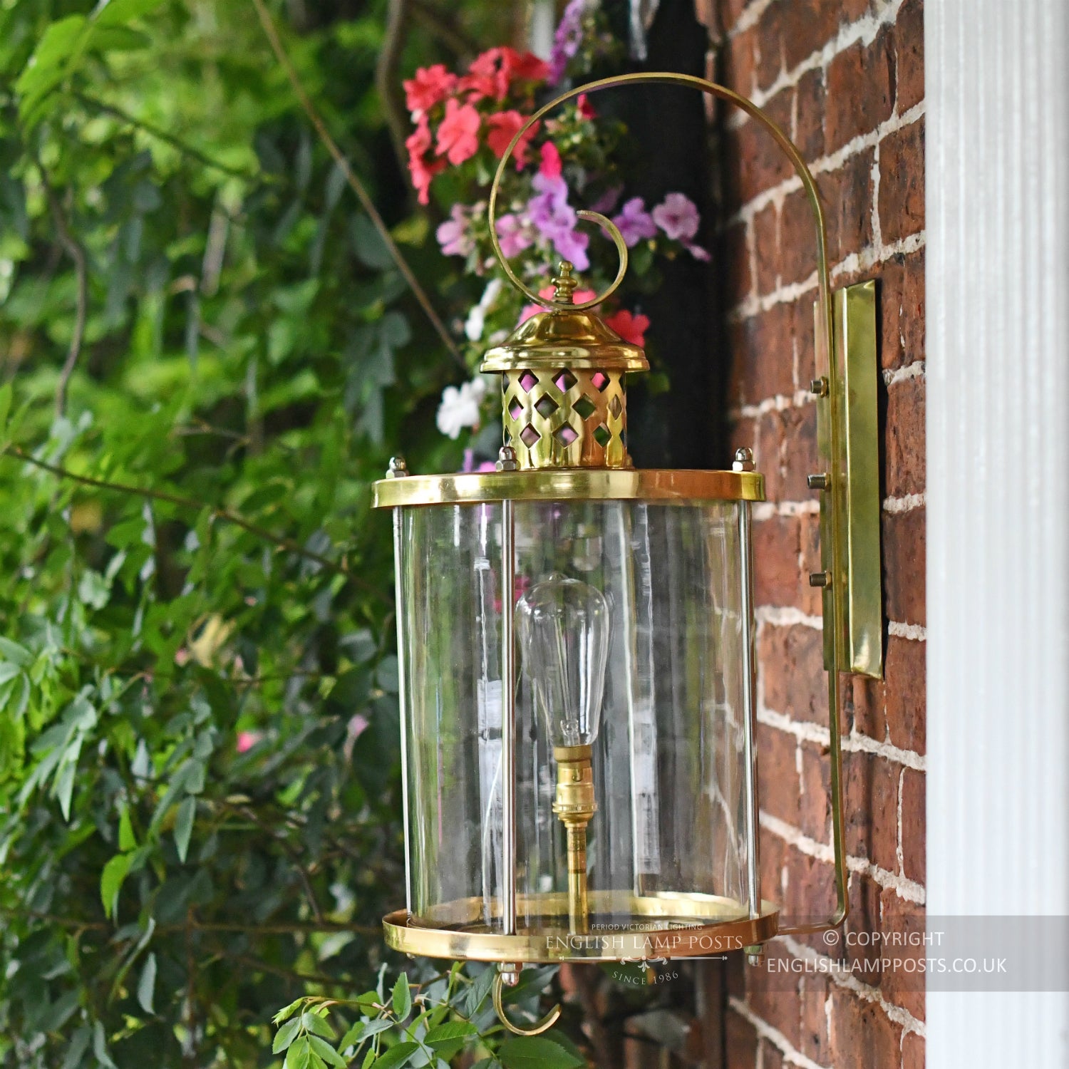 Large Polished Brass Top Fix Cylindrical Wall Light Installed On Brick Wall