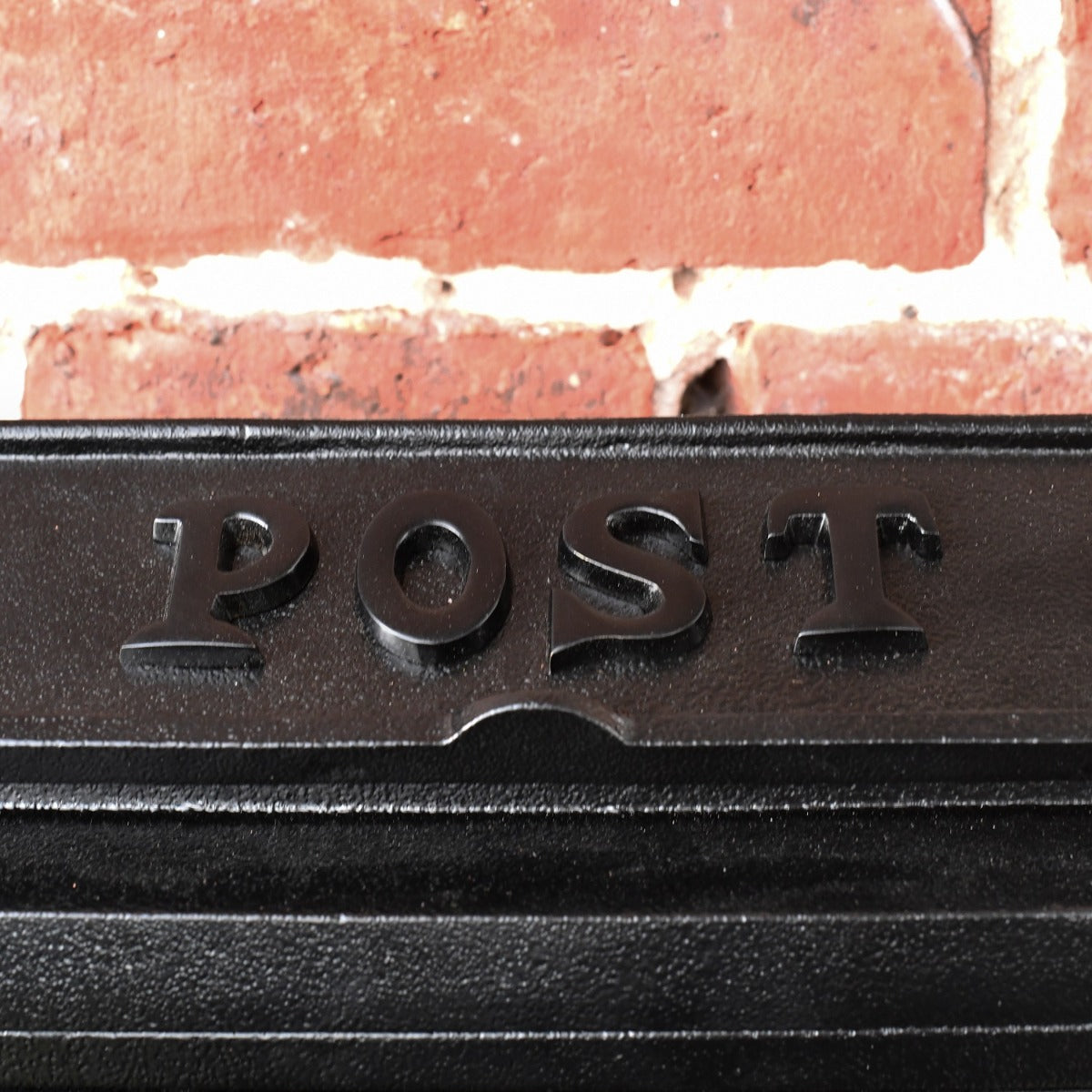 Close up of black lettering on post box 