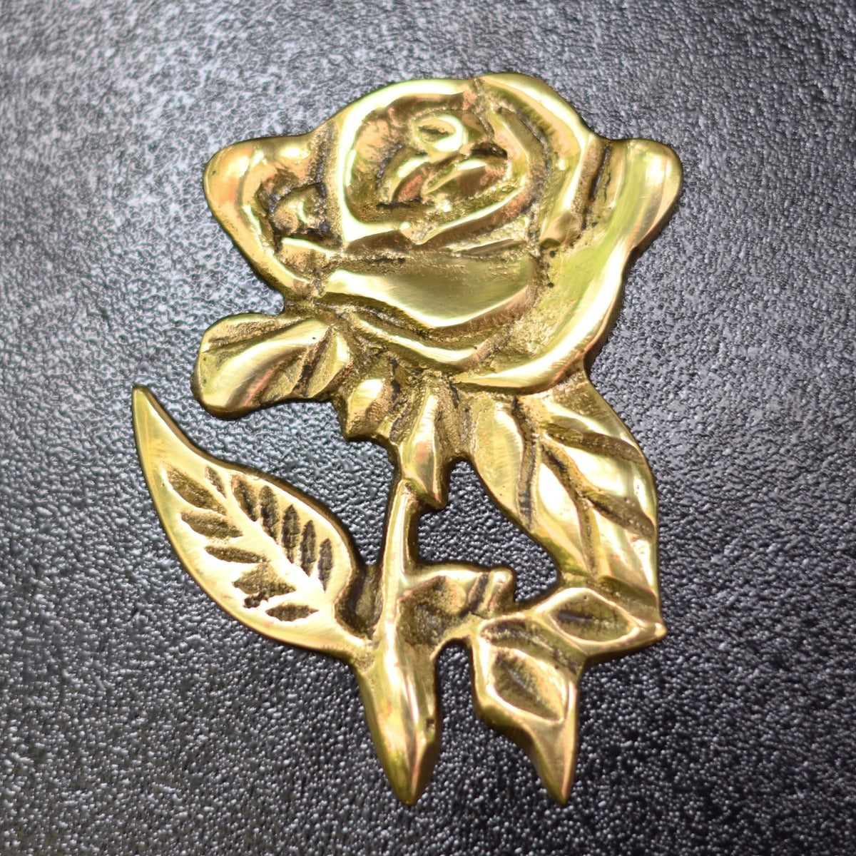 Close up of polished brass rose motif 