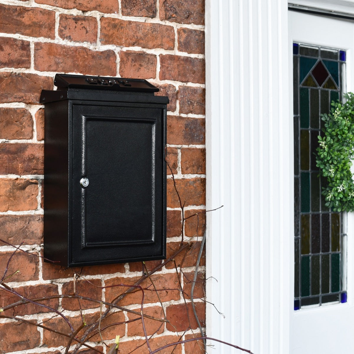 Side view of Black Simplistic Post Box near front door 