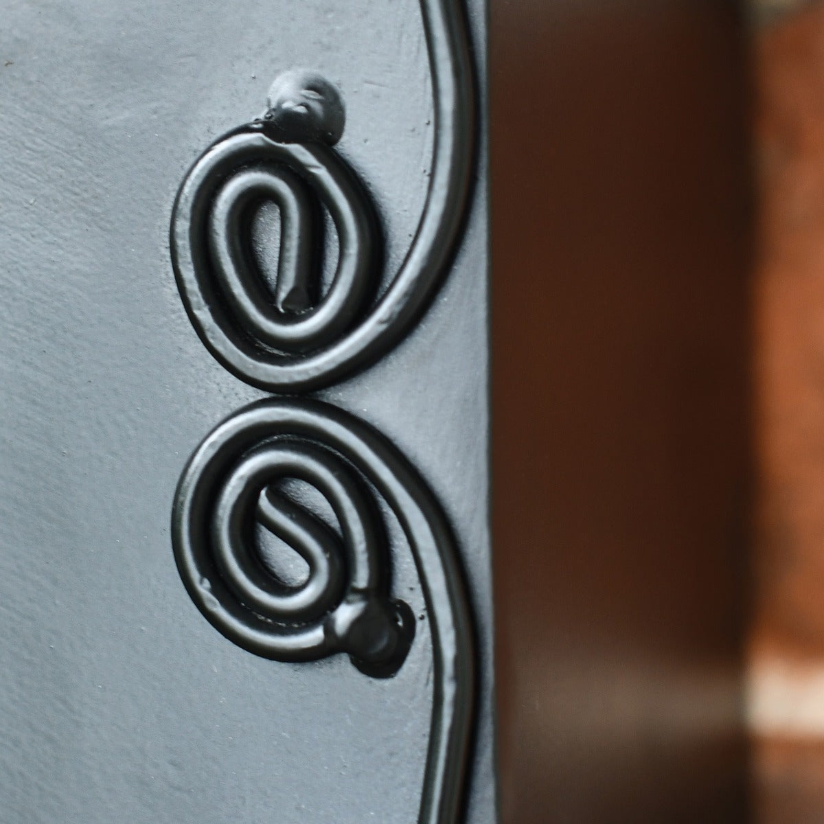 Close up of scroll work on post box 