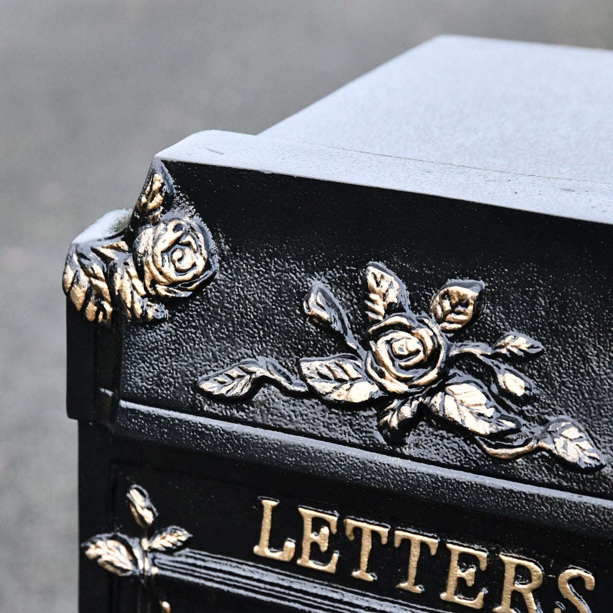 Close up of floral detailing on post box 