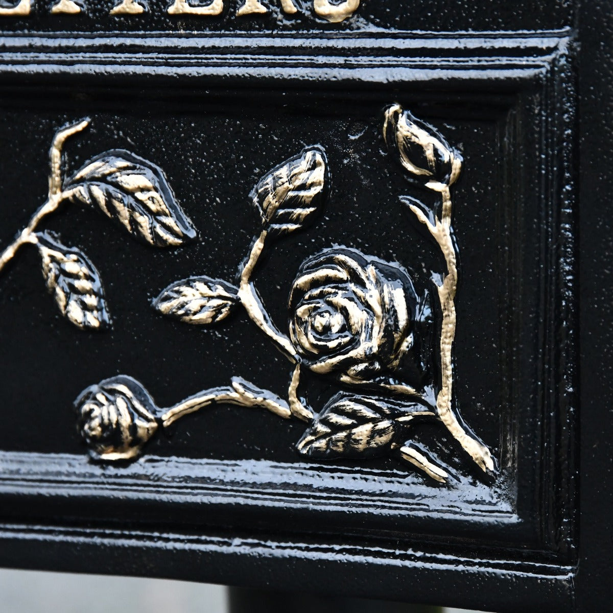 Close up of floral rose detailing on post box 