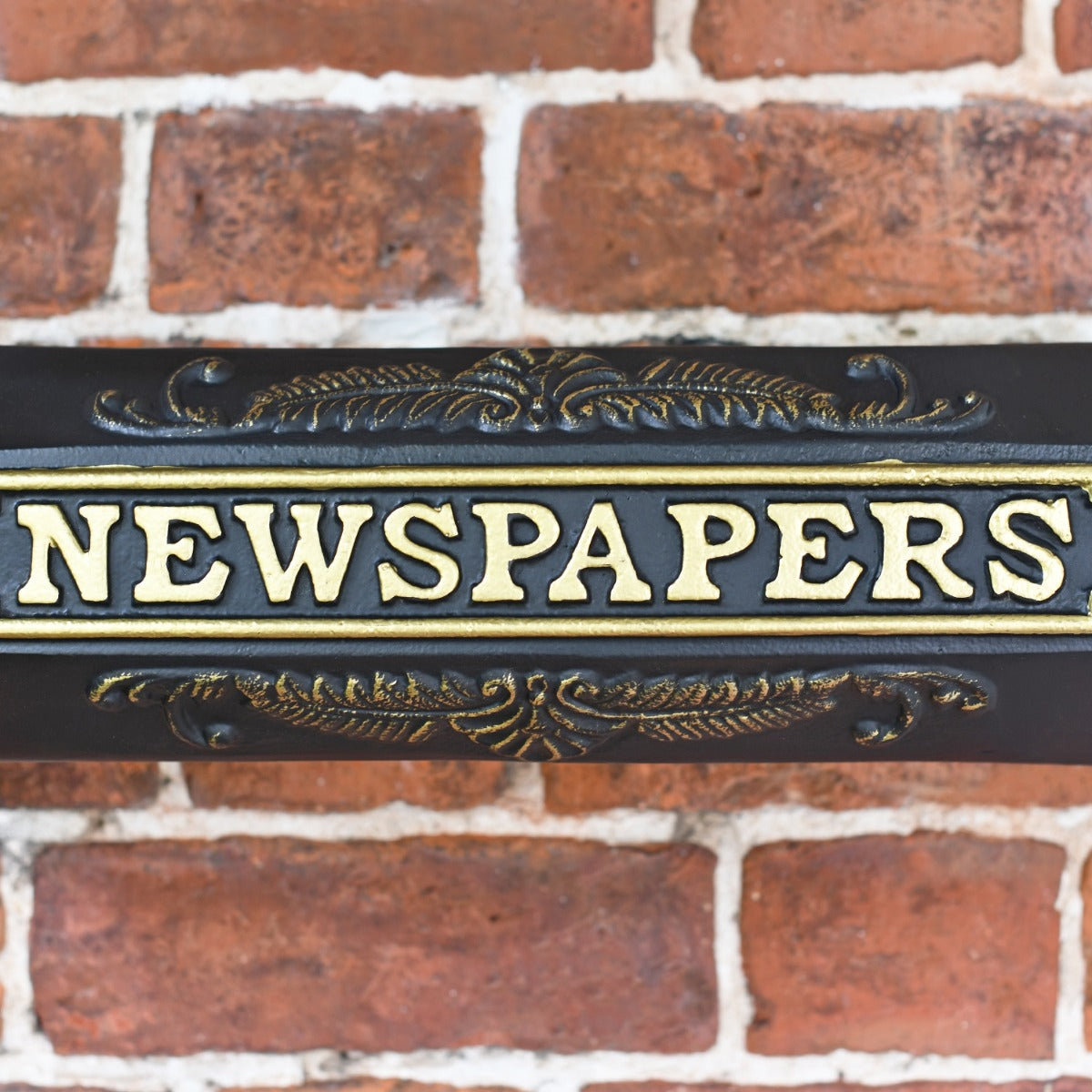 Close up of decorative detailing and wording of 'NEWSPAPERS'