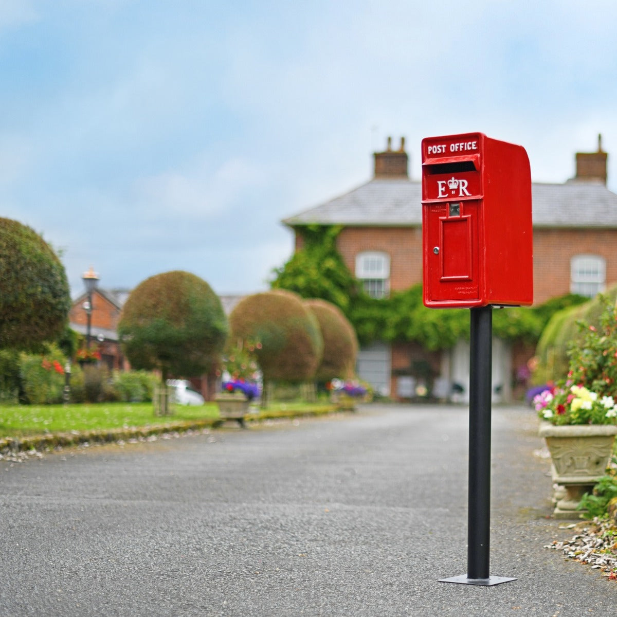 Elizabeth Regina Post Box in driveway setting 