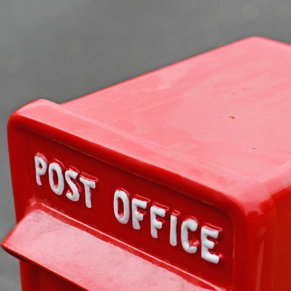 Close up of white lettering on post box top 
