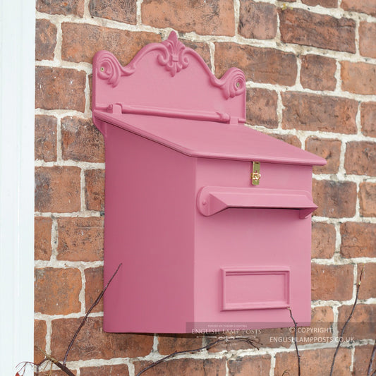 Pink Cambourne Secure Parcel Box on a red brick wall