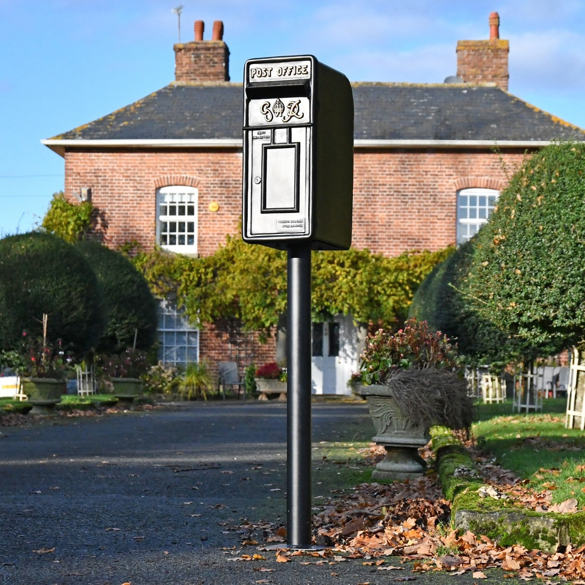 King George Black Post Box with Stand in driveway setting 