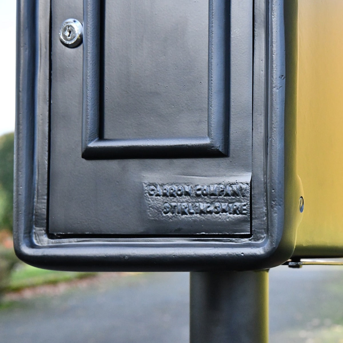 Close up of detailing on black King George post box 