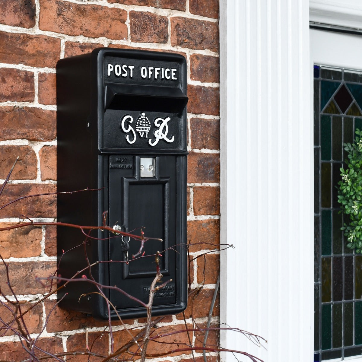Side view of wall mounted King George Post Box 