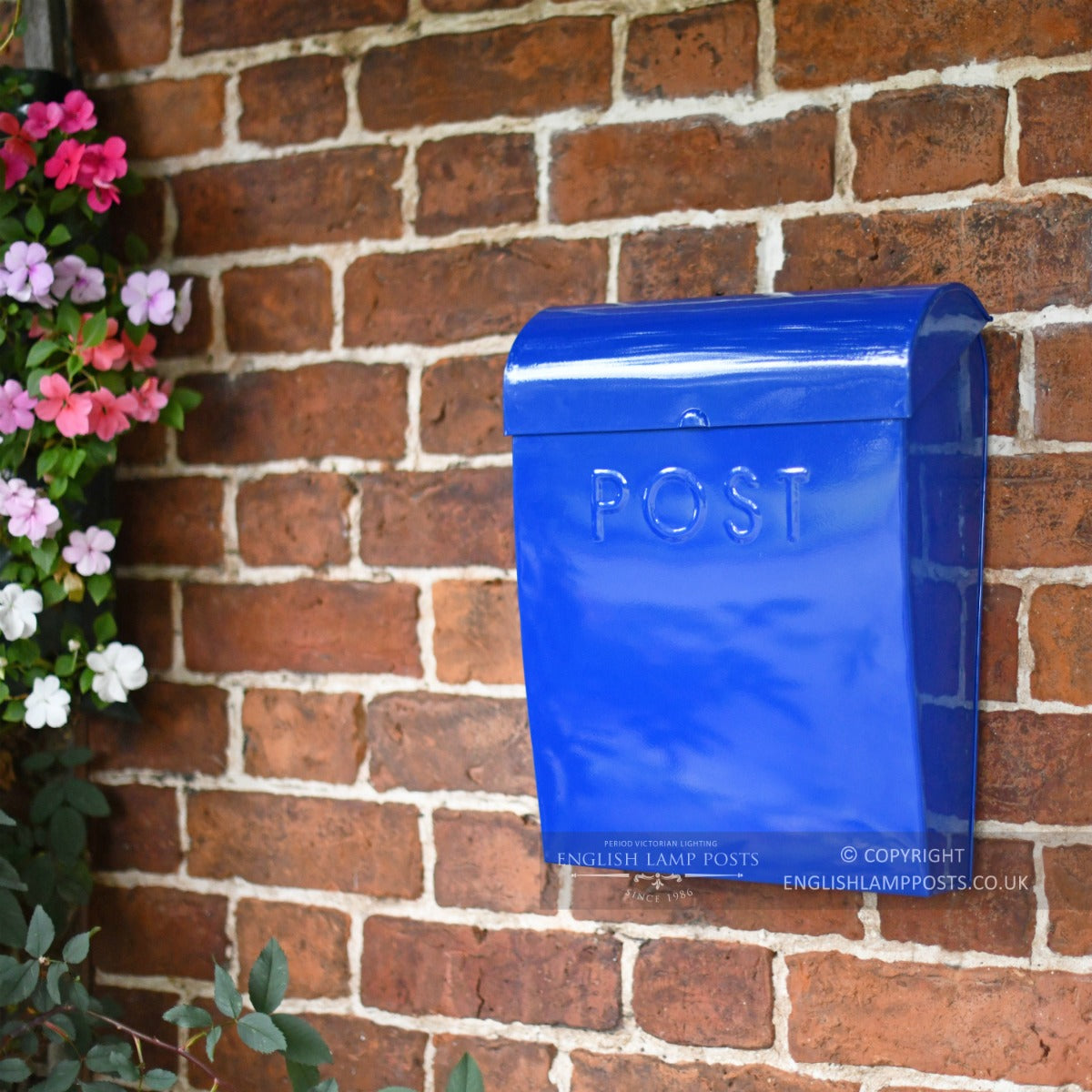 Contemporary post box on a red brick wall