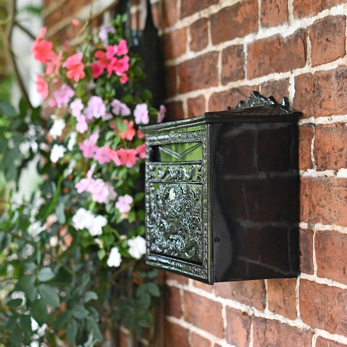 Side view of Black Ornate Victorian Post Box on wall 