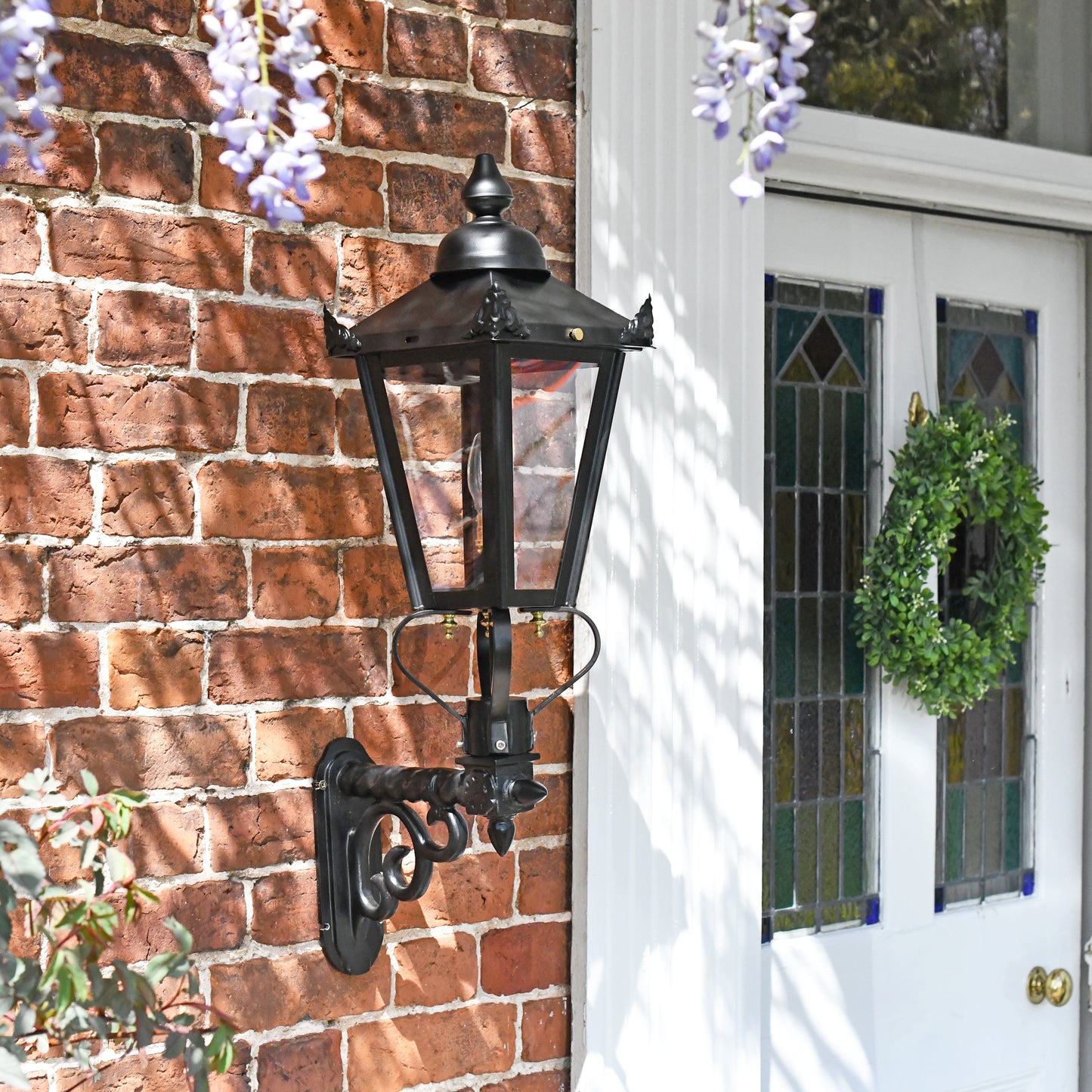 Garden lantern on royal bracket mounted on brick wall