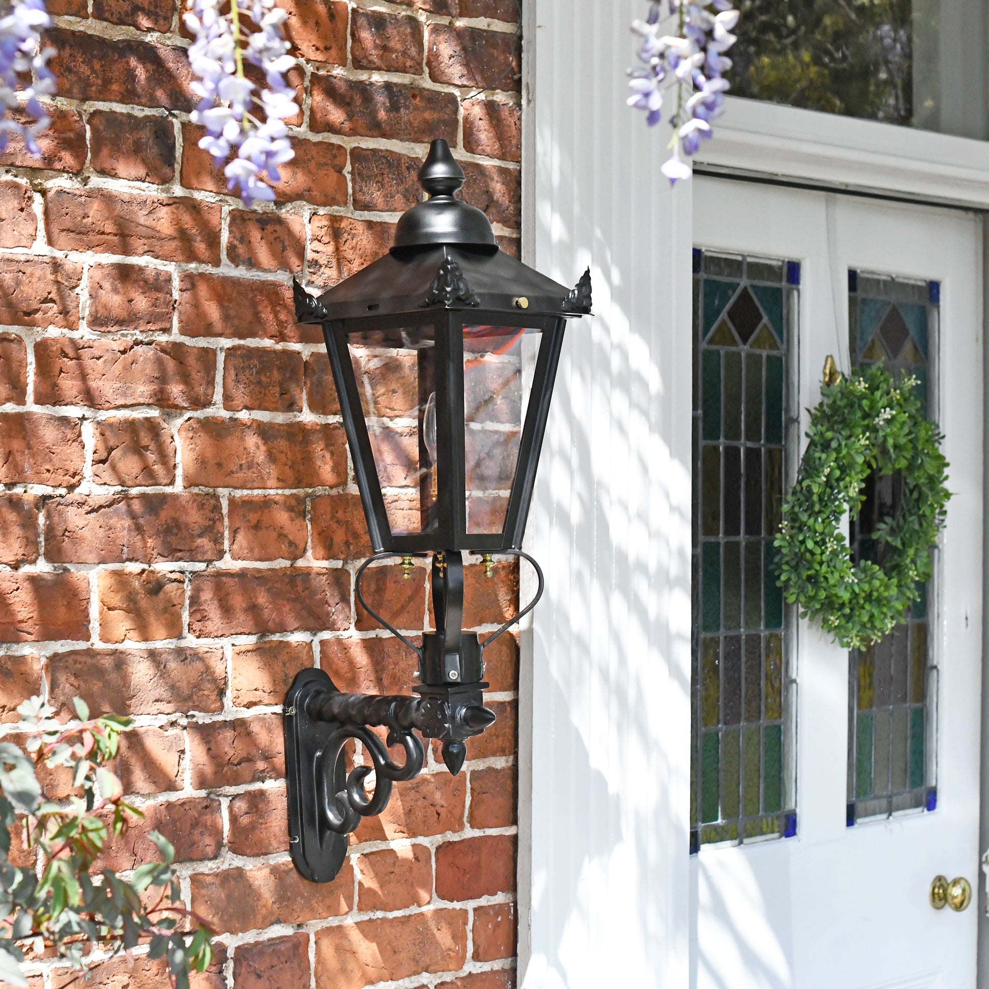 Garden lantern on royal bracket mounted on brick wall