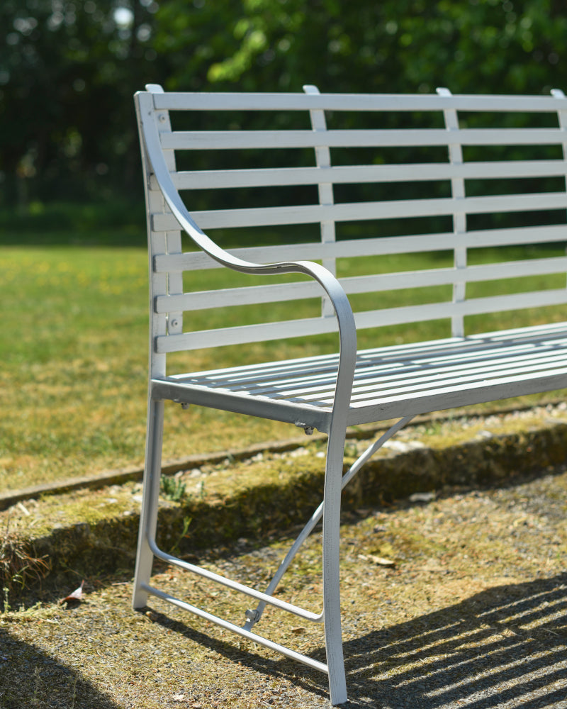 Side profile of the white three seater bench