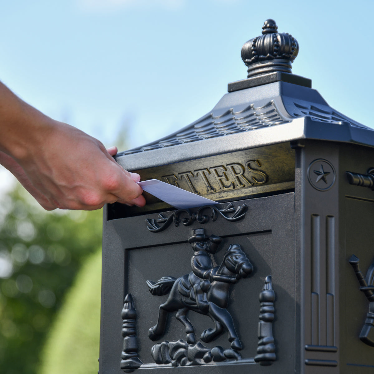 Mail being posted througnt the Matt Black 'Huntley' Freestanding Post Box
