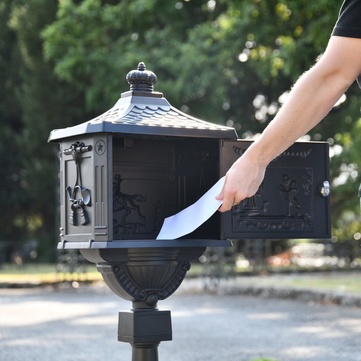 Mail being retrieved from the Matt Black 'Huntley' Freestanding Post Box