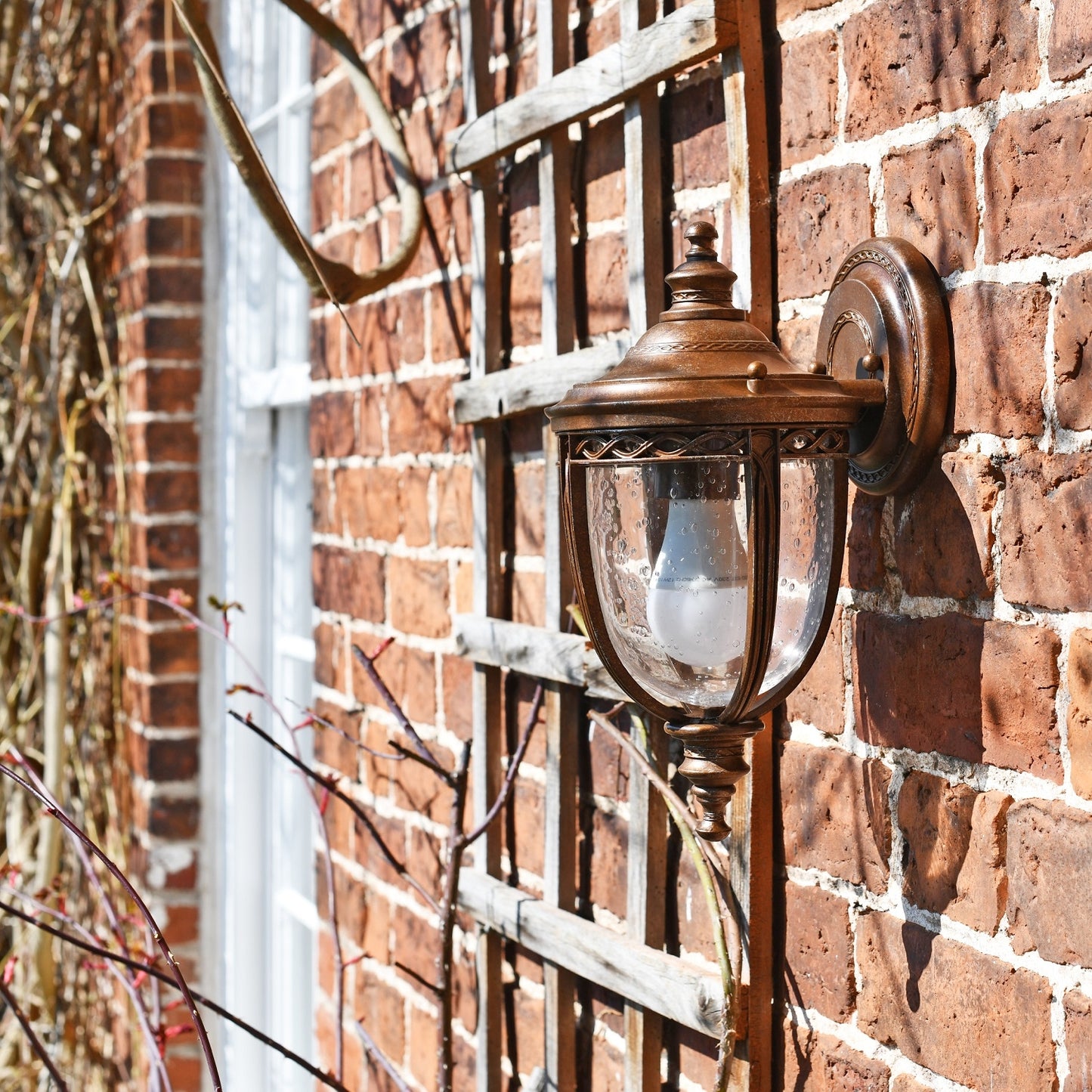 Period wall light ornate detailing on brick wall