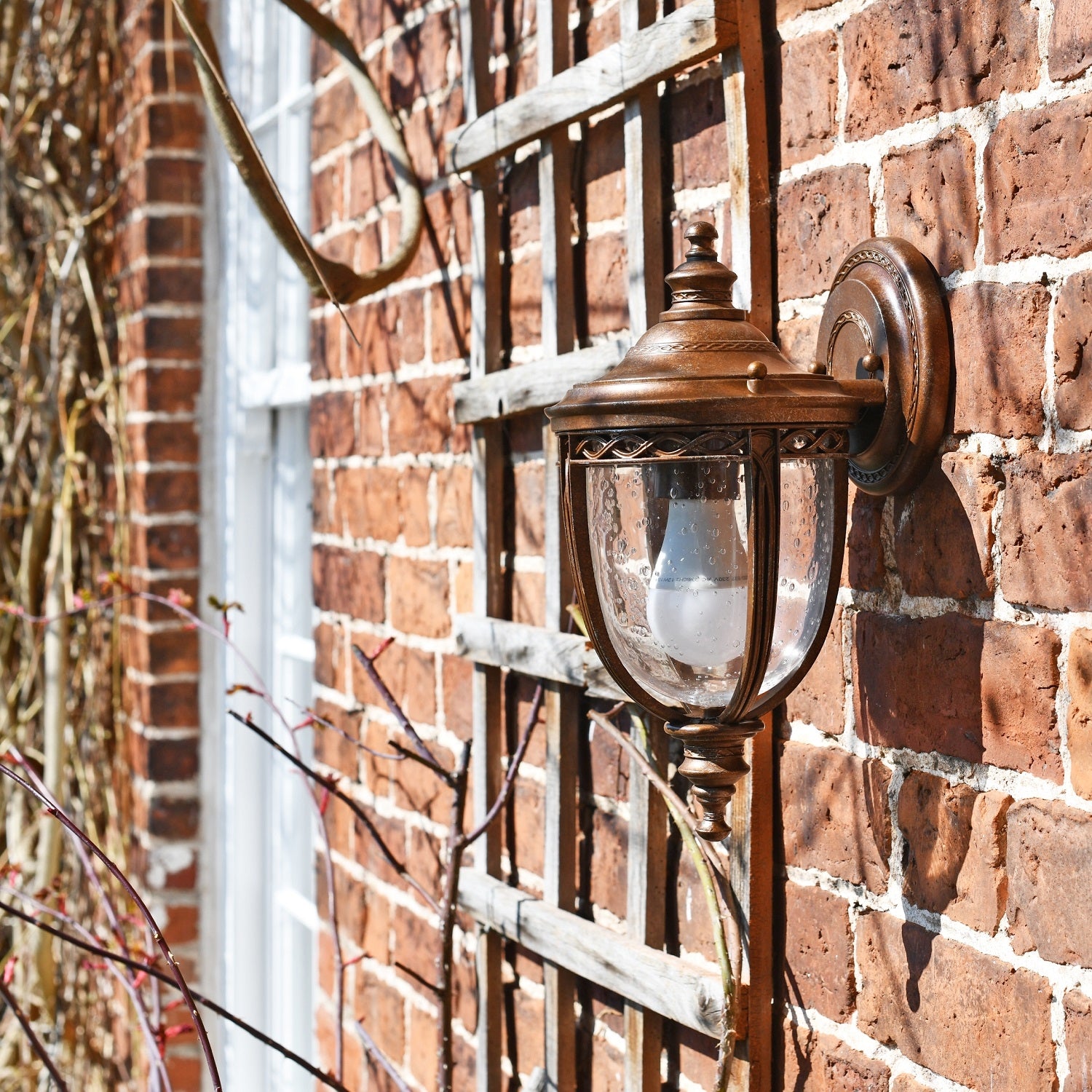 Period wall light ornate detailing on brick wall