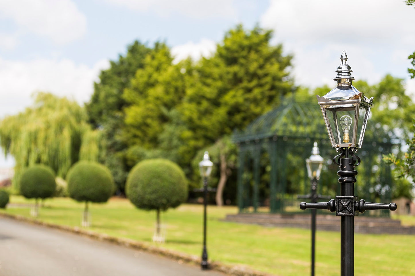 Polished Chrome Victorian Lamp Posts In Garden