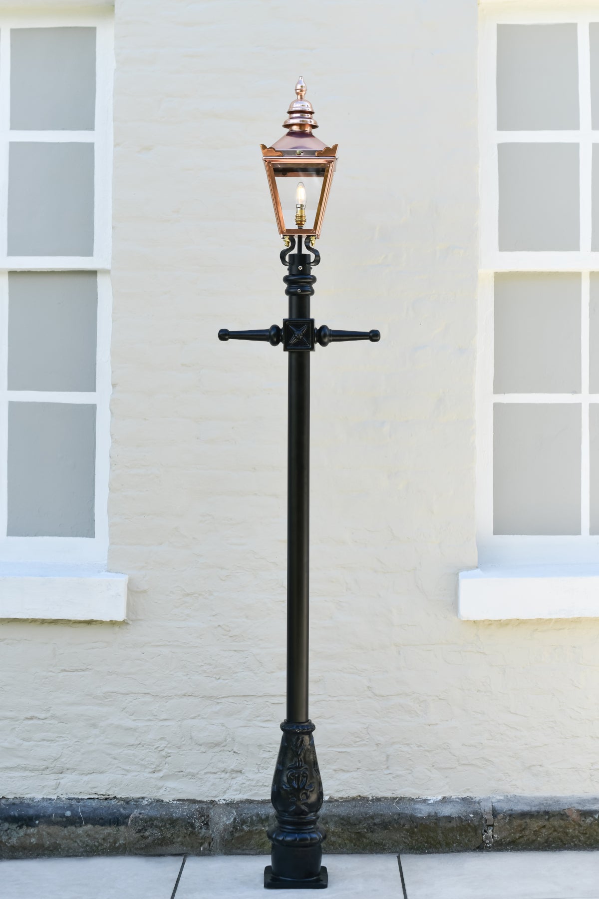 Head on shot of polished copper lamp post in real life setting