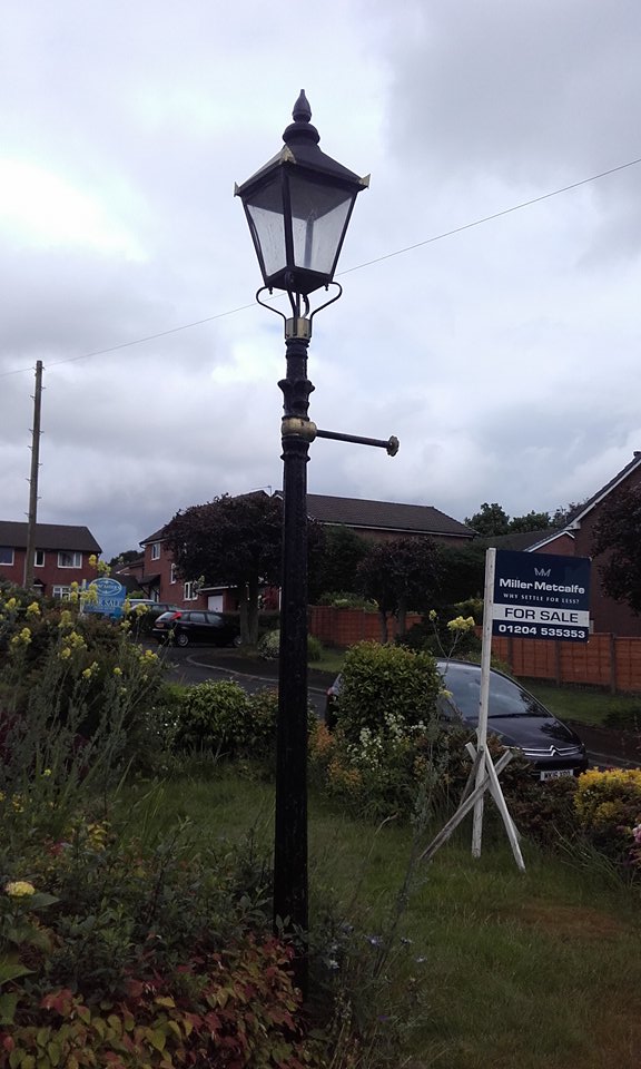 Reclaimed Black and Gold Iron Victorian Lamp Post In Garden Setting