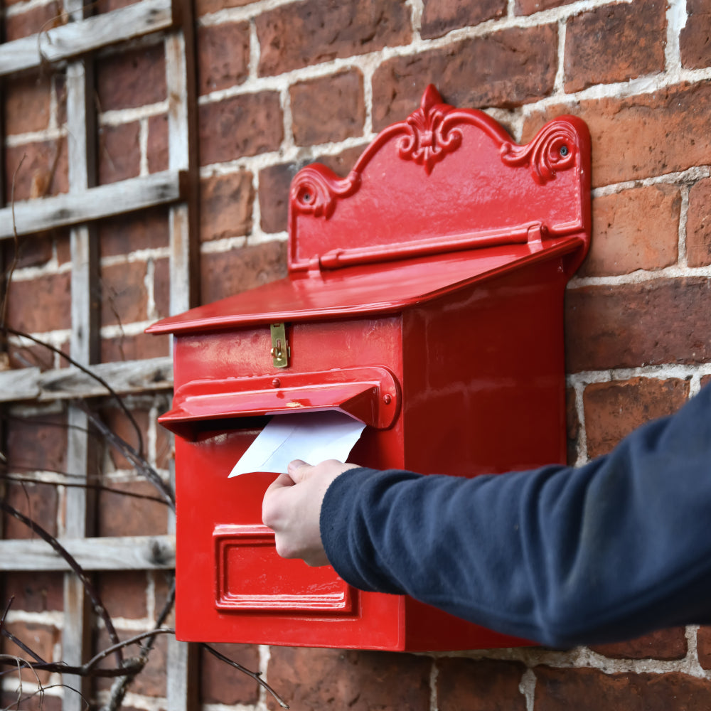 Life size scale of a letter being pushed through the flap