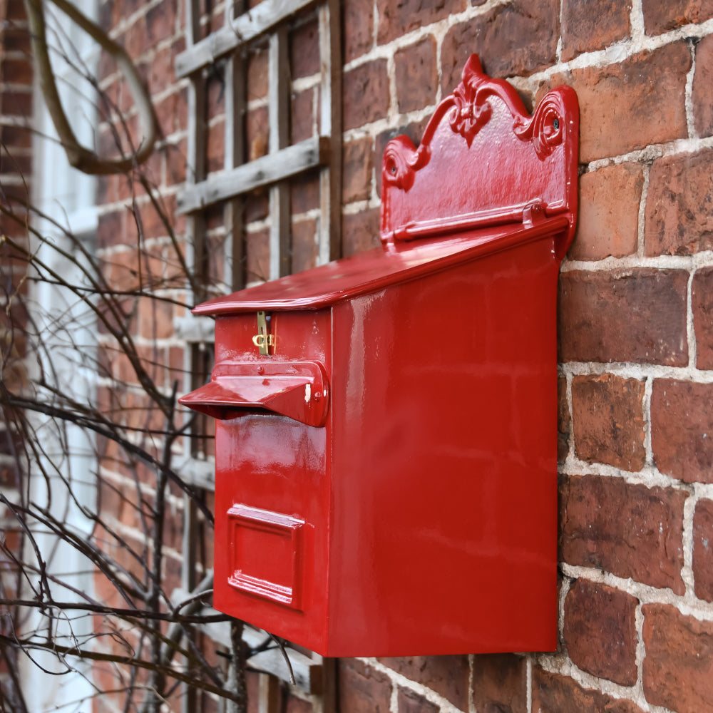 Side profile of the red post wall mountable post box
