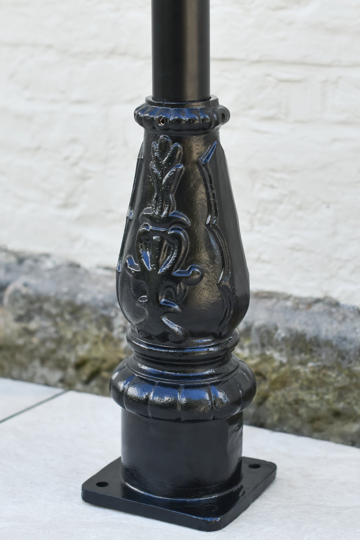 The cast iron embossed lamp post base