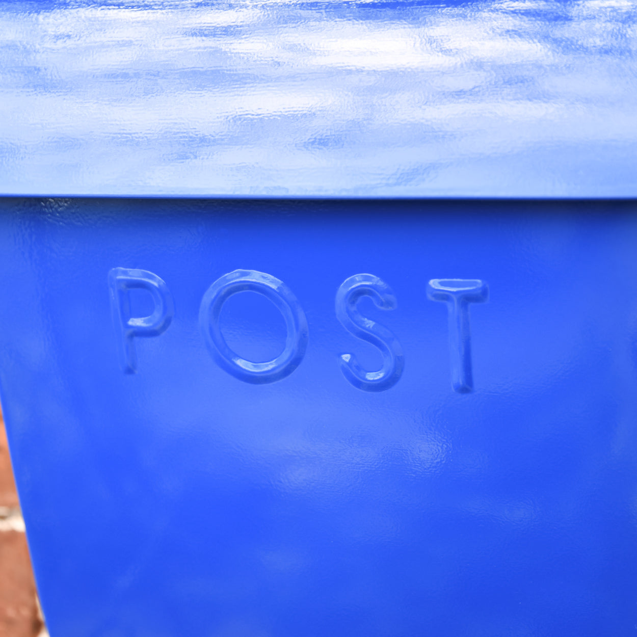The embossed lettering on the post box - POST