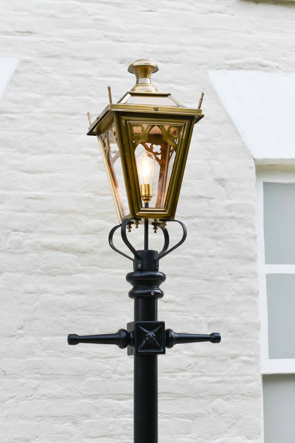 The lantern and ladder bars of the antique brass lamp post