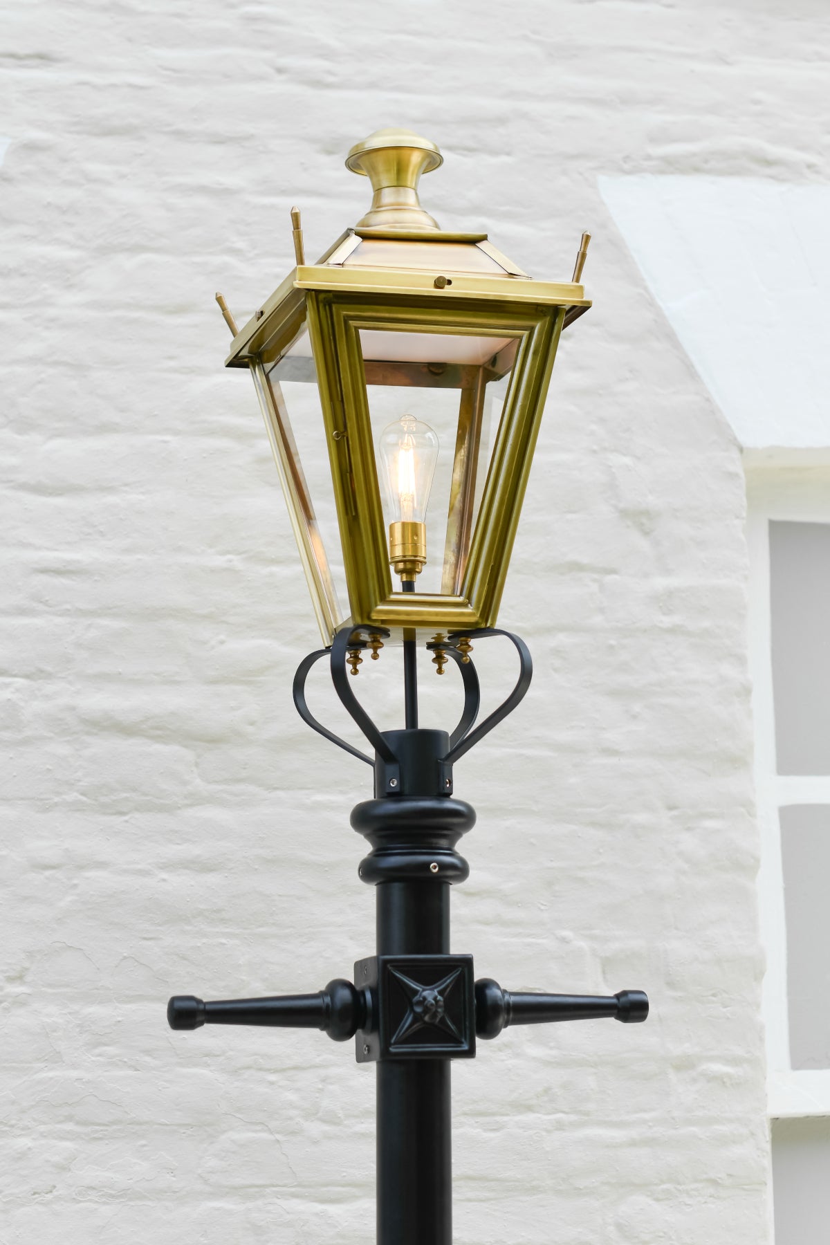 The lantern and ladder bars of the antique brass lamp post