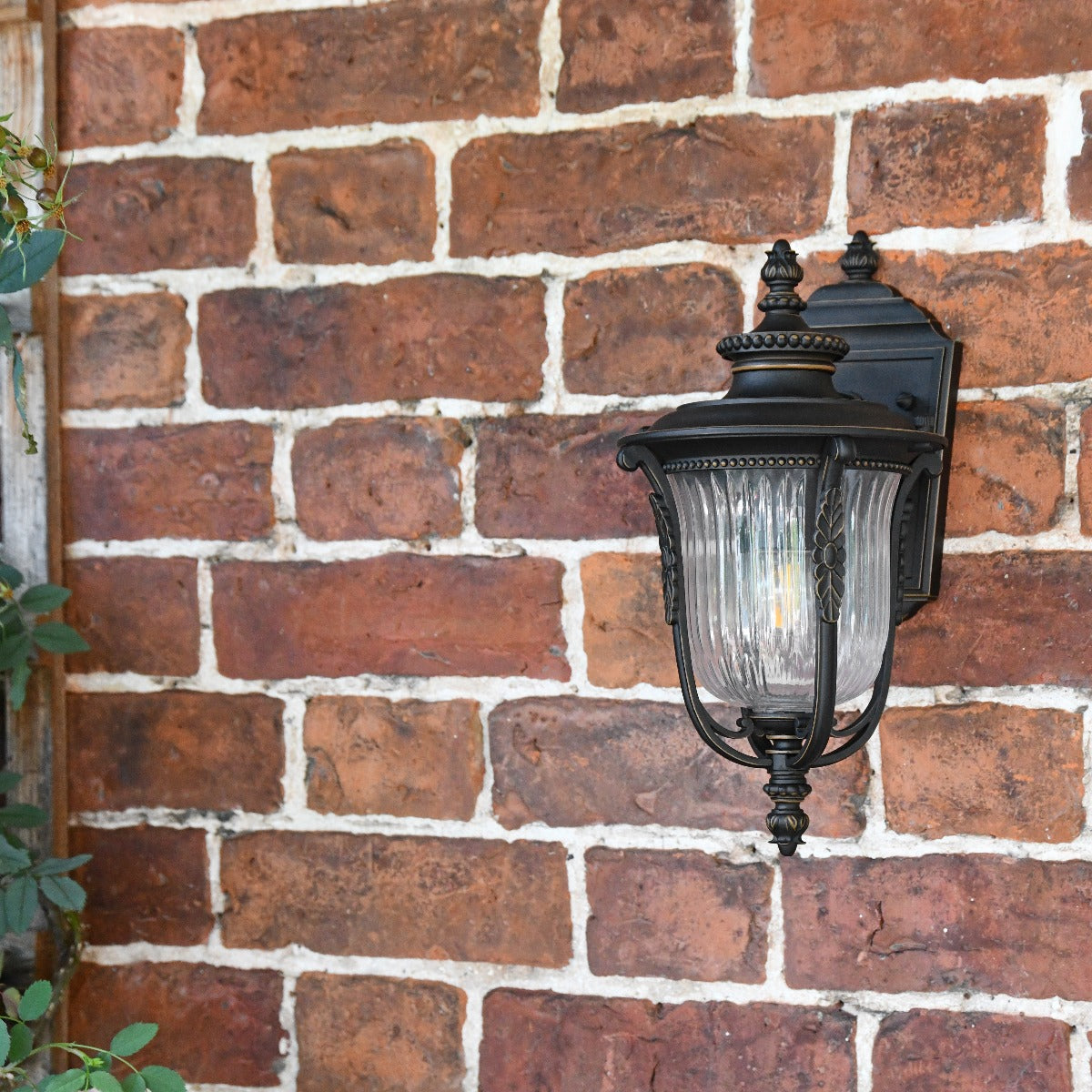 The Wilmont Bronze Ribbed Glass Lantern Installed on Brick Wall