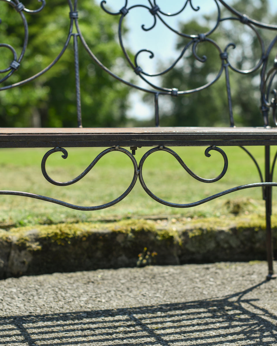 The scrolled finial at the base of the bench