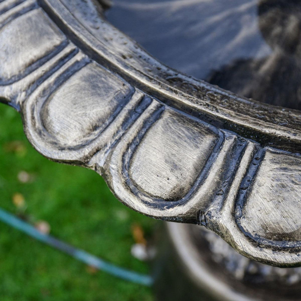 Magnified view of the ornate detailing on the water fountain edge