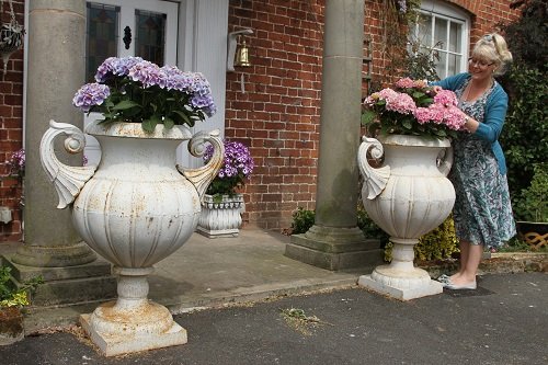 two cast iron white urns outdoors