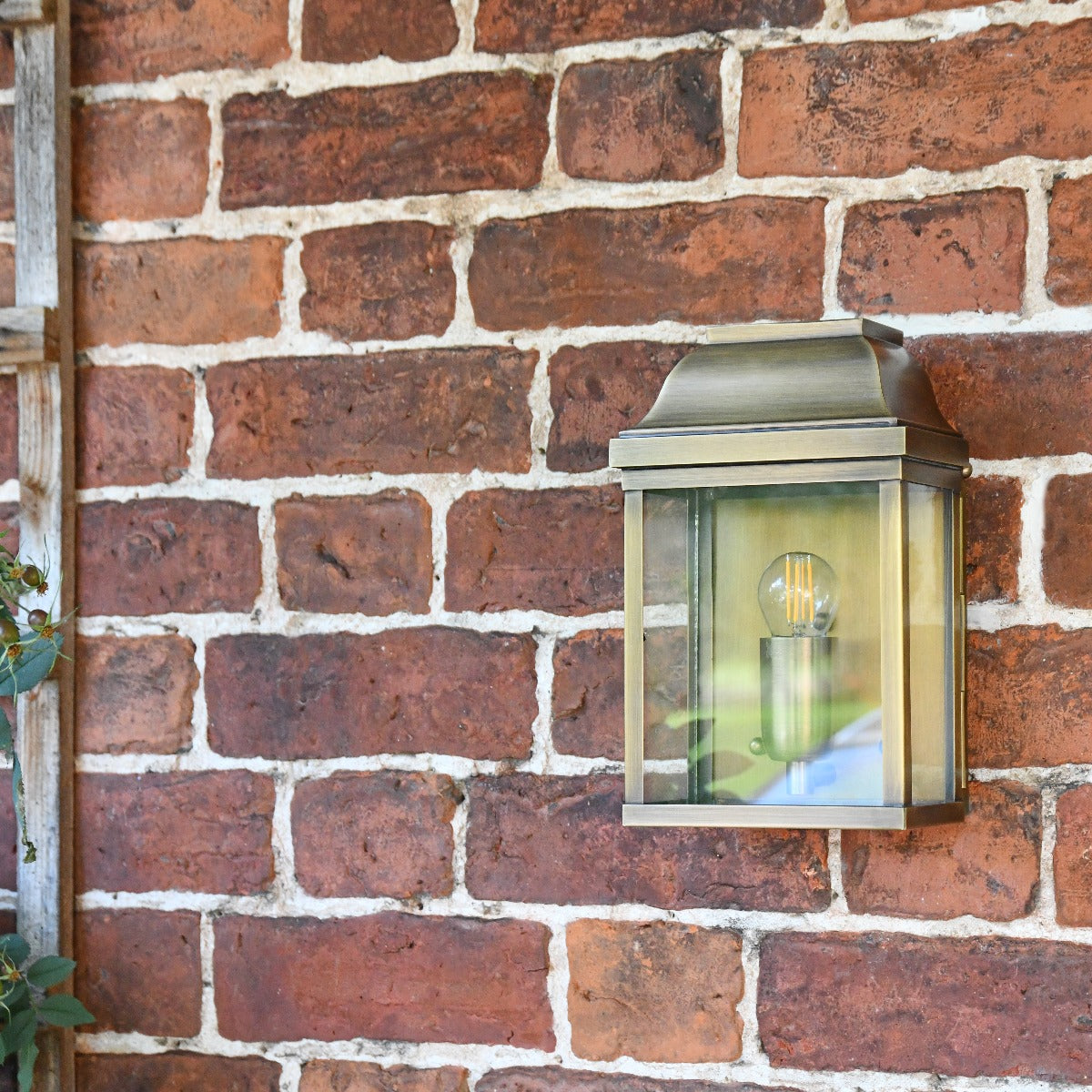 Antique Brass Flush Traditional Wall Lantern On Brick Wall