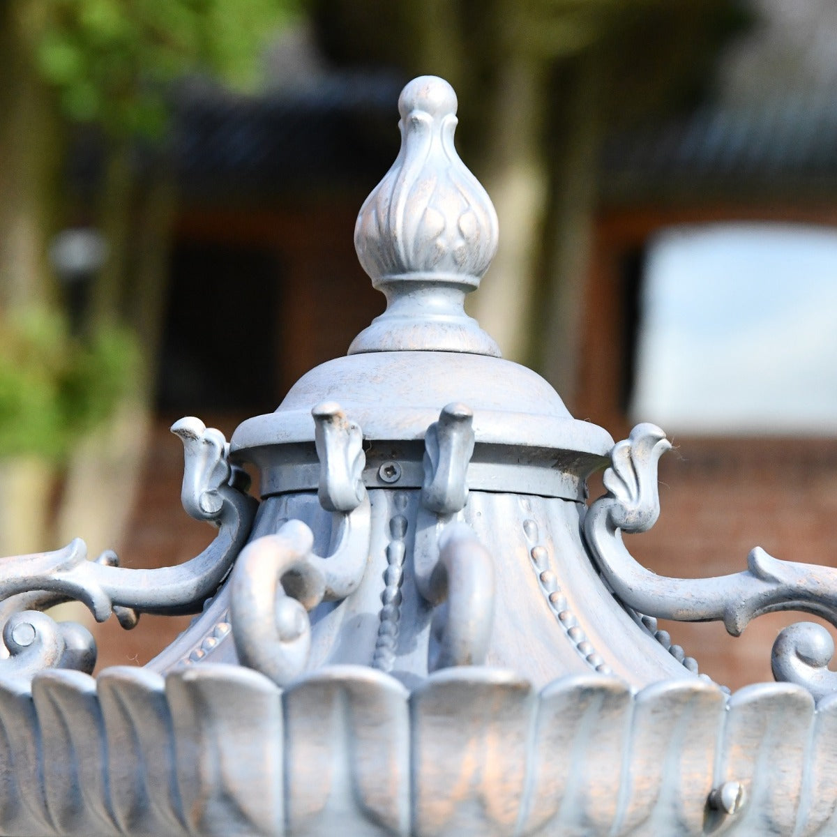 Close up of ornate finial on pillar light 