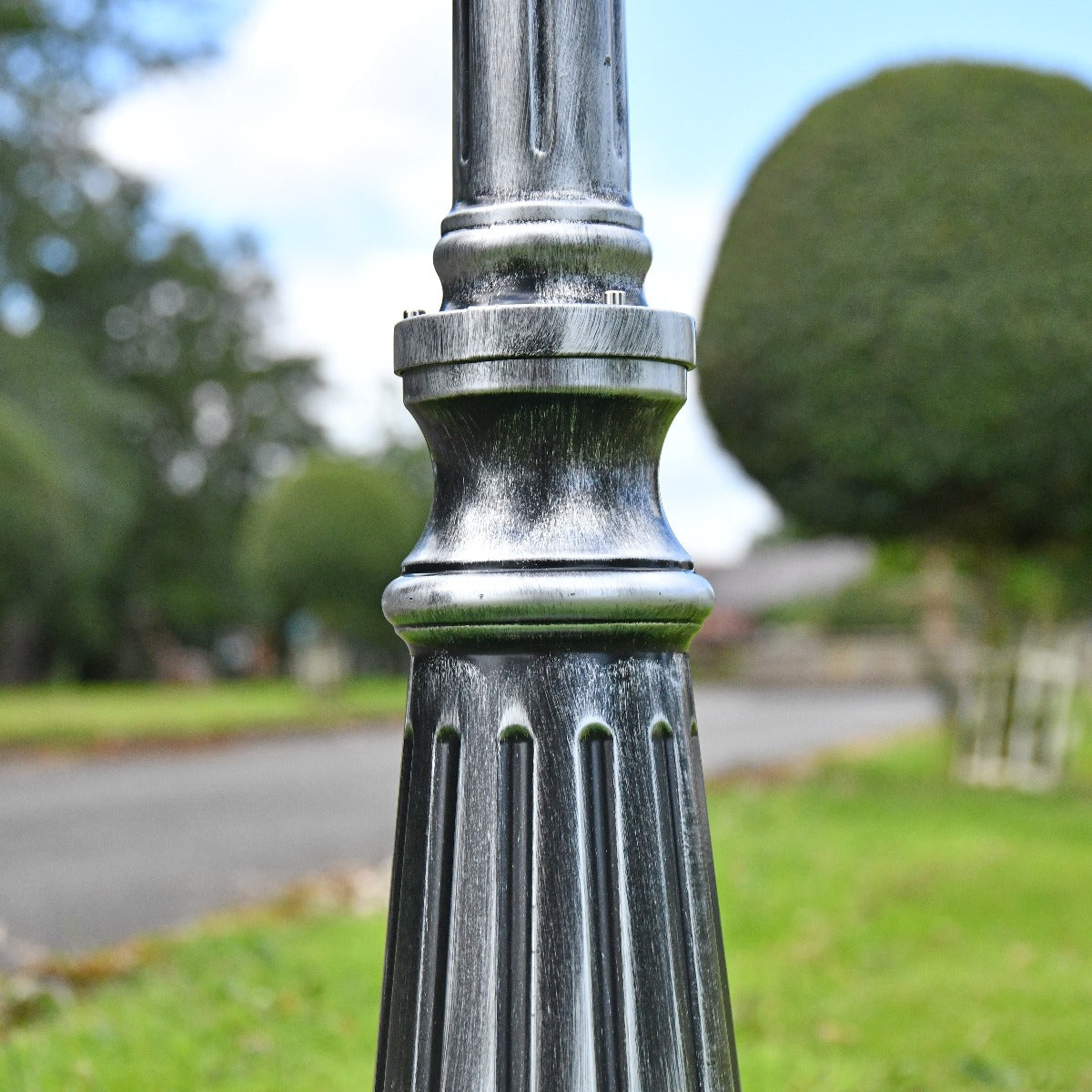 Close Up Of Antique Black and Silver Double Headed Garden Lamp Post