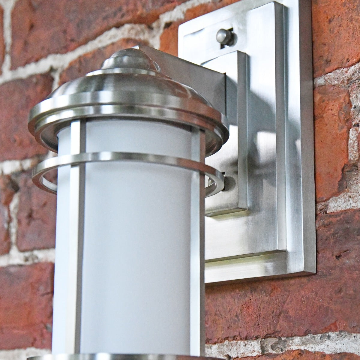 Close up of rectangular back plate and cylindrical lantern 